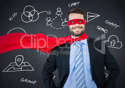Business man superhero with hands on hips against navy chalkboard with white business doodles