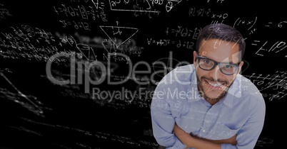 Digital composite image of businessman against blackboard with equations