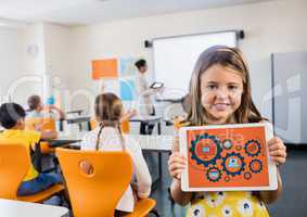 Kid in classroom with tablet showing gear graphics against orange background