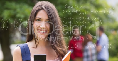 Portrait of smiling female collage student with math's equations on transparent screen