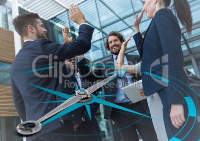 Business team high fiving and compass graphic