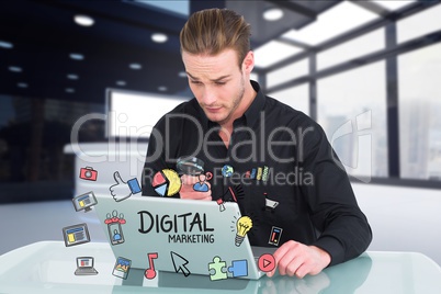 Businessman holding magnifying glass while digital marketing on laptop