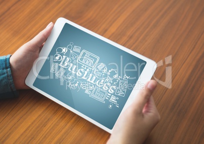 Hands with tablet showing white business doodles against blue background