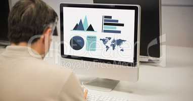 Rear view of businessman making graphs on computer
