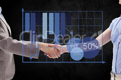Digital composite image of business partners shaking hands by graph