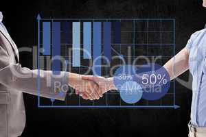 Digital composite image of business partners shaking hands by graph