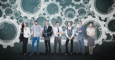 Digitally generated image of business people standing against gears in background
