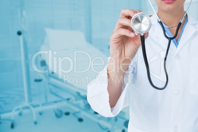 Midsection of doctor holding stethoscope