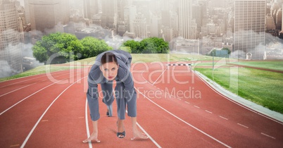 Businesswoman in  starting position on tracks
