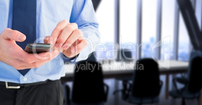 Business executive using smart phone in office