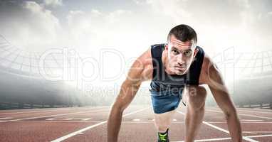 Male runner on track against flares