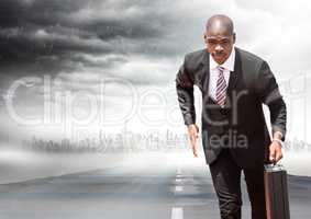 Business man with briefcase running on road with skyline and storm