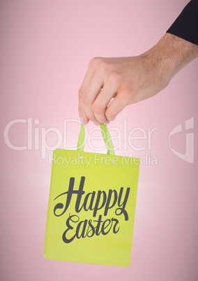 Hand holding green bag with with type against pink background