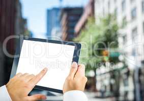 Hands with tablet in the city