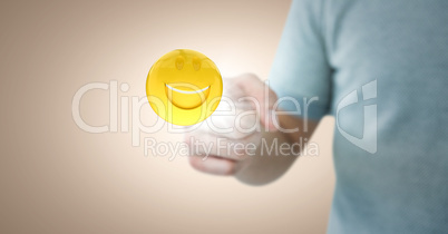 Man in tshirt pointing at emoji with flare against cream background