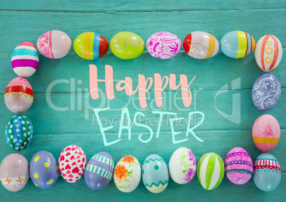 Blue and pink type surrounded by easter eggs on teal table