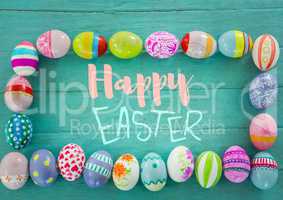 Blue and pink type surrounded by easter eggs on teal table