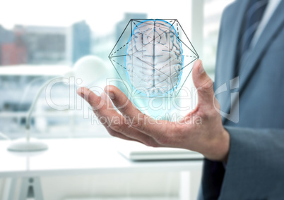 Brain with hexagon graphic in the hand of a business man