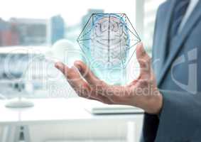 Brain with hexagon graphic in the hand of a business man