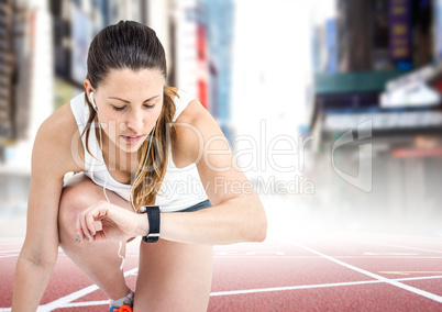Female runner with headphones on track against blurry city