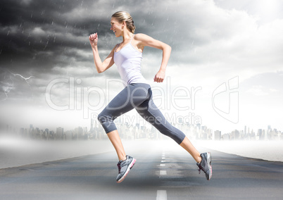Female runner going across road with skyline and storm