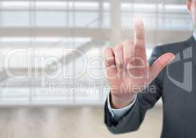 Businessman touching air in front of glass room