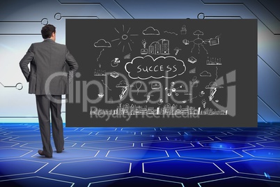 Businessman looking at success text surrounded by various icons on blackboard