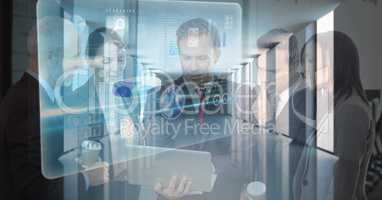 Digital composite image of business people using laptop with icons in office