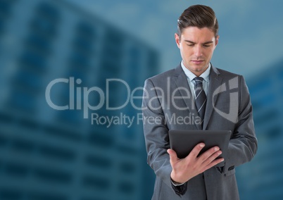 Businessman on tablet against blue background