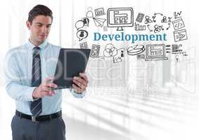 Businessman with tablet and Development text with drawings graphics