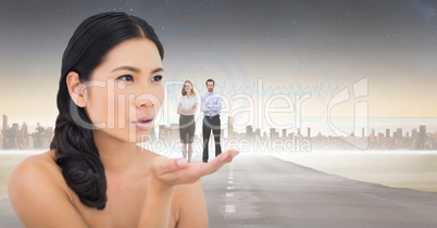 Digitally generated image of woman with business people standing on palm against city