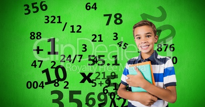 Digitally generated image of boy holding books with numbers flying against green background