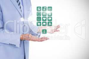 Digitally generated image of businessman holding various icons against white background