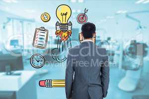Rear view of businessman looking at icons