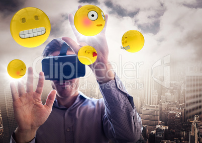 Man in VR with hands up touching flares and emojis against skyline and clouds