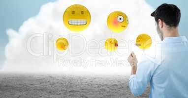 Back of man with emojis and flare against cloud