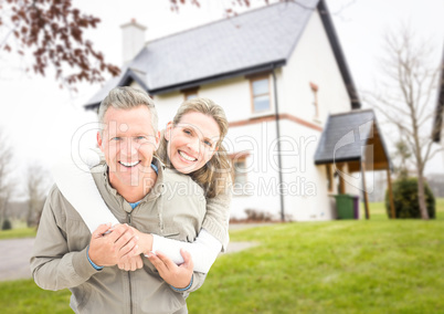 Couple in front of their house