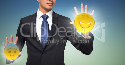 Business man mid section with flares and emojis on hands against blue green background