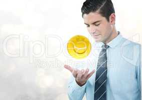 Business man with hand open and emoji with flare against white bokeh