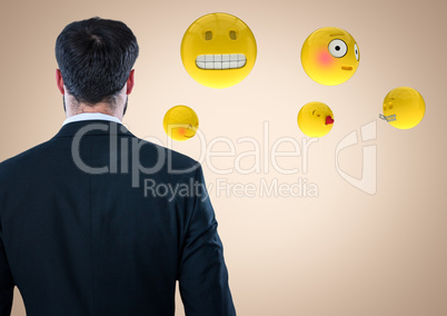 Back of business man with emojis against cream background