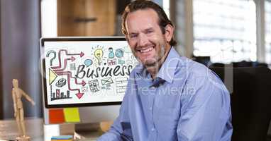 Portrait of smiling businessman sitting in office with various icons on copmuter screen
