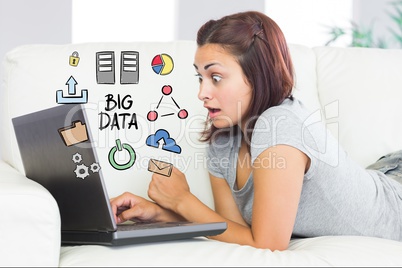 Digitally generated image of surprised woman using laptop with big data diagram at home