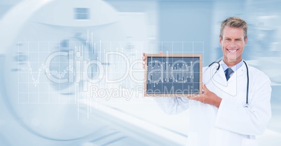 Digitally generated image of male doctor showing slate with pulse and MRI scan machine in background