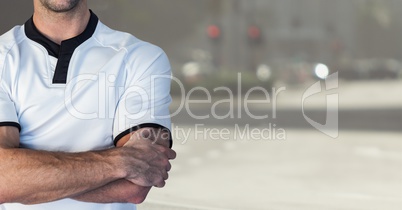 Sporty men with his hands folded on blurred background of the city