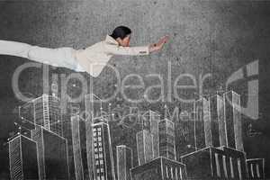 Digital composite image of business superhero flying over buildings