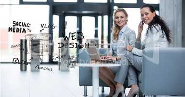 Happy businesswomen with laptop and text in office