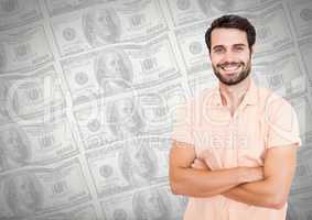 Man smiling with arms folded i front of money notes