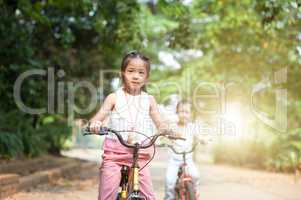Children riding bikes outdoor.