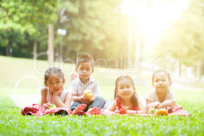 Happy Asian children picnics outdoor.