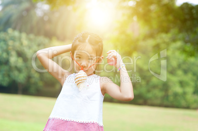 Asian child playing toy at outdoors.